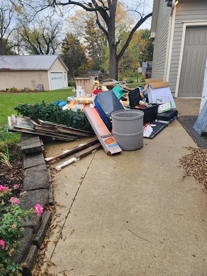Dumpster being loaded with debris for 3 Yard Dumpster Rental in North Fond du Lac